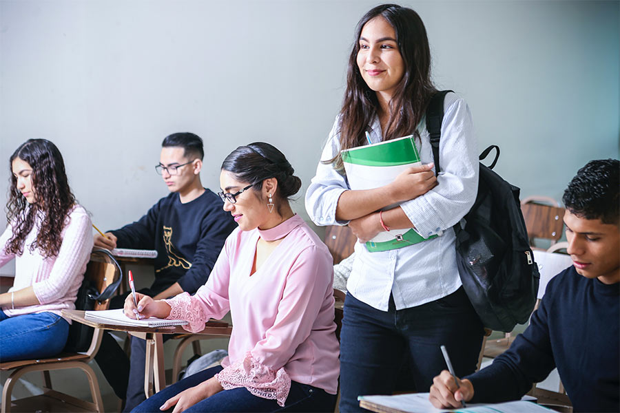 woman walking in a classroom